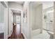 Hallway leading to a bathroom with subway tile and bathtub at 624 Woodward St, Lakeland, FL 33803