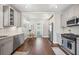 Galley kitchen with stainless steel appliances, granite counters, white subway tile backsplash, and hardwood floors at 624 Woodward St, Lakeland, FL 33803