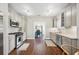 Well-lit galley kitchen with stainless steel appliances and lots of cabinet space open to dining room at 624 Woodward St, Lakeland, FL 33803