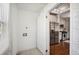 Laundry room with patterned tile floor and view into kitchen with stainless steel appliances at 624 Woodward St, Lakeland, FL 33803