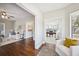 Open-concept view from living room to sunroom with hardwood floors and neutral-toned decor at 624 Woodward St, Lakeland, FL 33803