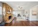 Cozy living room with a stone fireplace, hardwood floors, and a view of the dining room at 624 Woodward St, Lakeland, FL 33803