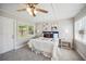 Inviting main bedroom with ceiling fan, neutral carpet and paint colors, and bright natural light at 624 Woodward St, Lakeland, FL 33803