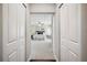 View into main bedroom featuring neutral paint colors and carpet through closet doors at 624 Woodward St, Lakeland, FL 33803