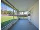 Screened porch with grey flooring and view of the grassy backyard at 624 Woodward St, Lakeland, FL 33803