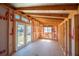 Interior view of the shed under construction with exposed beams, double doors, and natural light at 624 Woodward St, Lakeland, FL 33803