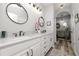 Bathroom features a double sink marble vanity, an arched doorway and modern lighting at 6329 Torrington Cir, Lakeland, FL 33811