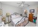 Relaxing bedroom featuring a decorative bed frame, ceiling fan and ample natural light at 6329 Torrington Cir, Lakeland, FL 33811