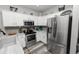 Modern kitchen featuring stainless steel appliances, white cabinets, and ample counter space at 6329 Torrington Cir, Lakeland, FL 33811