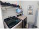 A modern laundry room with front-loading washer and dryer and ample storage shelves at 6329 Torrington Cir, Lakeland, FL 33811