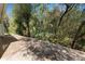 A brick patio with bird feeders creates a relaxing outdoor living space surrounded by lush, natural landscaping at 6329 Torrington Cir, Lakeland, FL 33811