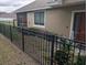 Home exterior featuring a fenced yard, manicured landscaping, and a brick-paved walkway at 6397 Torrington Cir, Lakeland, FL 33811