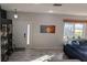 Living room with wood floors, an accent wall, and natural light from a large window at 6397 Torrington Cir, Lakeland, FL 33811