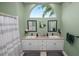 Bathroom featuring double sinks, large mirrors, and decorative accents at 7211 Scenic Hills Blvd, Lakeland, FL 33810