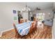 Bright dining area with wood-look flooring, an adjacent kitchen, and a table set for a pleasant meal at 7211 Scenic Hills Blvd, Lakeland, FL 33810