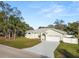 Inviting single-story home with a two-car garage and freshly landscaped front yard at 7211 Scenic Hills Blvd, Lakeland, FL 33810