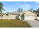 Charming single-story home featuring a well-manicured lawn and attached two-car garage at 7211 Scenic Hills Blvd, Lakeland, FL 33810