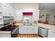 Modern kitchen with stainless steel appliances, white cabinets, and warm countertops at 7211 Scenic Hills Blvd, Lakeland, FL 33810