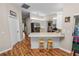 Well-lit kitchen with wood-look flooring, a breakfast bar, and modern stainless steel appliances at 7211 Scenic Hills Blvd, Lakeland, FL 33810