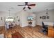 Spacious living area featuring wood-look flooring, a dining set, and a wall-mounted TV for entertainment at 7211 Scenic Hills Blvd, Lakeland, FL 33810