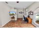 Bright living area featuring wood-look floors, a dining area and a compact office nook at 7211 Scenic Hills Blvd, Lakeland, FL 33810