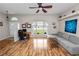 Bright living room with wood-look flooring, a gray sofa, and a large window providing natural light at 7211 Scenic Hills Blvd, Lakeland, FL 33810