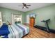 Spacious main bedroom featuring wood floors, ceiling fan, and access to the outdoors at 7211 Scenic Hills Blvd, Lakeland, FL 33810