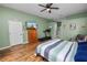 Spacious main bedroom offering wood floors, ceiling fan, and ensuite bathroom at 7211 Scenic Hills Blvd, Lakeland, FL 33810