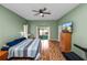 Spacious main bedroom showing wood floors, ceiling fan, and a calming atmosphere at 7211 Scenic Hills Blvd, Lakeland, FL 33810