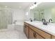 Modern bathroom with double sinks, a soaking tub, and a glass-enclosed shower at 750 W Vine St, Bartow, FL 33830