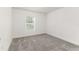 Cozy bedroom with plush carpet, white walls and a window at 750 W Vine St, Bartow, FL 33830