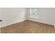 Minimalist bedroom with wood-look floors and a window providing natural light at 750 W Vine St, Bartow, FL 33830