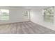 Bright bedroom with plush gray carpet and abundant natural light from three windows at 750 W Vine St, Bartow, FL 33830