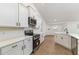 Modern kitchen featuring white cabinets, stainless steel appliances, and wood-look floors at 750 W Vine St, Bartow, FL 33830