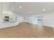 Bright, open living room with wood-look tile flooring, white trim and natural light at 750 W Vine St, Bartow, FL 33830