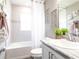 Bathroom featuring a shower-tub combo, decorative mirror, vanity with countertop and chrome faucet, and decor at 7597 Sw 107Th Ln, Ocala, FL 34480