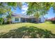 Lush green backyard with a screened lanai, perfect for outdoor living at 940 Ashton Oaks Cir, Lakeland, FL 33813