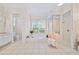 This spacious primary bathroom features a tub, shower, vanity, and charming wallpaper at 940 Ashton Oaks Cir, Lakeland, FL 33813