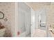 Bathroom with a tub/shower, floral wallpaper, and white tile flooring at 940 Ashton Oaks Cir, Lakeland, FL 33813