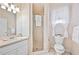 Bright bathroom with floral wallpaper, glass shower, and white vanity at 940 Ashton Oaks Cir, Lakeland, FL 33813