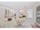 Bright breakfast nook features a chandelier, white tile flooring, and charming floral wallpaper at 940 Ashton Oaks Cir, Lakeland, FL 33813