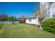 Exterior view of the home featuring a manicured lawn and mature landscaping at 940 Ashton Oaks Cir, Lakeland, FL 33813