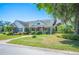 Beautifully landscaped single-story home featuring a welcoming front porch and lush surroundings at 940 Ashton Oaks Cir, Lakeland, FL 33813