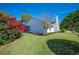 Rear exterior view of a charming home with lush landscaped yard at 940 Ashton Oaks Cir, Lakeland, FL 33813