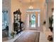 Bright foyer with tiled floor, chandelier, and an antique cabinet on display at 940 Ashton Oaks Cir, Lakeland, FL 33813