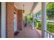 Inviting front porch features brick flooring and classic white columns at 940 Ashton Oaks Cir, Lakeland, FL 33813