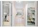 View down hallway featuring a closet, shoe closet, and bathroom with bright white interior at 940 Ashton Oaks Cir, Lakeland, FL 33813