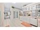 Bright kitchen with white cabinets and modern appliances, adjacent to a breakfast nook and doorway at 940 Ashton Oaks Cir, Lakeland, FL 33813