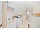 Functional laundry room with white cabinets, modern appliances, and tile floor at 940 Ashton Oaks Cir, Lakeland, FL 33813