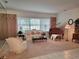 Cozy living room featuring a grand piano, comfortable seating, and a large window at 940 Ashton Oaks Cir, Lakeland, FL 33813